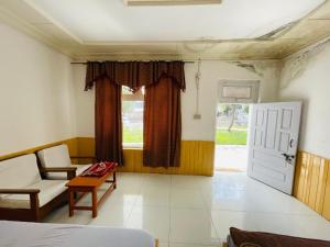 a room with a bed and a chair and a window at four star hotel and rest in Mingāora