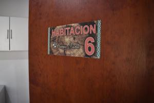 a sign on a door with the number at Sampa Pacha - Cabaña 6 - Habitación privada in Bialet Massé