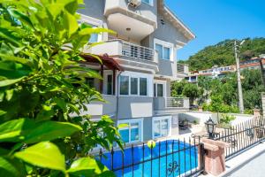 a building with a swimming pool in front of it at Villa Necati Bey in Marmaris