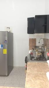 a kitchen with a stove with pots and pans on it at Apartamentos Vacacionales in Manta