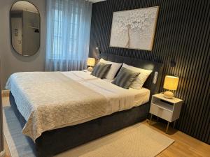 a bedroom with a large bed and a mirror at Auberge de Vianden in Vianden