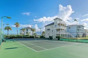 a tennis court in front of a apartment building at Beach Access with Elevator & FREE Activities in Gulf Shores