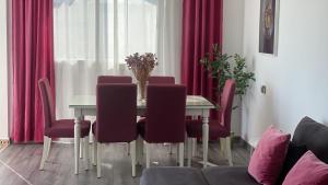 a dining room with a table with purple chairs at Cabo Beach Home 1 in Cabo Negro