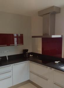 a kitchen with white cabinets and black counter tops at El Rompido in El Rompido
