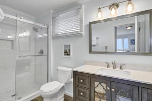 a bathroom with a toilet and a sink and a shower at Seagrove 11D by Wild Dunes, Oceanfront Condo in Isle of Palms