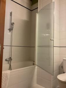 a bathroom with a shower and a tub and a toilet at Hotel Cuevas Del Mar in Nueva de Llanes