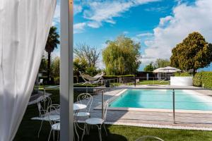 a view of the pool from the balcony of a house at Villa Riviera Hotel Udine in Pradamano