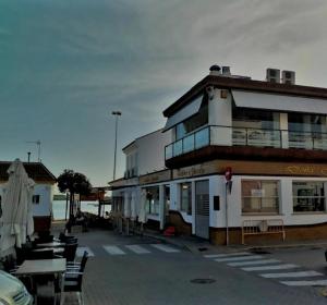 a building with tables and chairs in a parking lot at El Rompido in El Rompido +7 photos