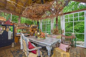 a dining room with a table and chairs and windows at A Mammoth Cave Getaway in Park City