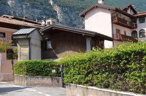 a house with a mountain in the background at Residenza Al Capitello in Ceniga