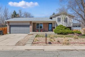 a house with a parking meter in front of it at Spacious 4BD - Backyard BBQ, Fire Pit & Mini Golf in Arvada