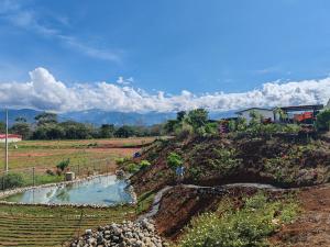 a hill with a pool of water in a field at Apartamento con dos habitaciones in San Isidro