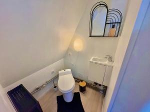 a small bathroom with a toilet and a sink at Jolie Duplex - Grand place - Hyper centre-Netflix in Arras +10 photos