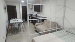 a room with a bed and a desk and a table at Franco l in Posadas