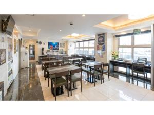 a dining room with tables and chairs in a restaurant at Hotel Koza - Vacation STAY 84847v in Okinawa City