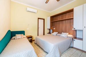 Postel nebo postele na pokoji v ubytování Hotel Bamby e Delfino