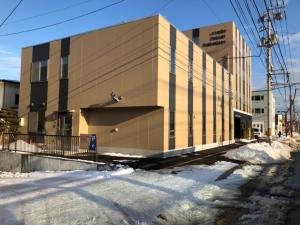 ein Gebäude an einer Straße mit Schnee davor in der Unterkunft Credo Hotel Hakodate - Vacation STAY 87584v in Hakodate