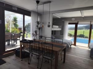 a living room with a dining table and a bedroom at Gaia Bareyo in Bareyo