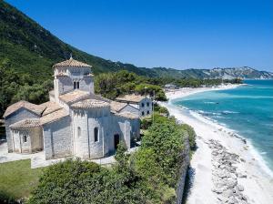 a building on a hill next to a beach at La casa di Agnese by Homes in Ancona in Ancona