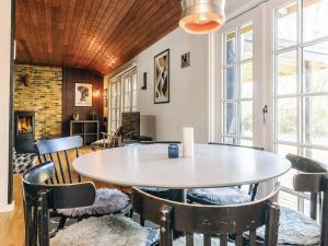 a dining room with a table and chairs at 6 person holiday home in Rødby in Rødby +28 photos