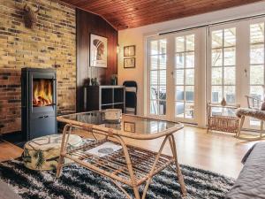 a living room with a brick wall and a fireplace at 6 person holiday home in Rødby in Rødby