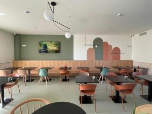 a dining room with tables and chairs and a counter at Hotel Capital in Cupra Marittima