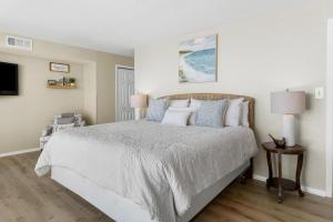 a bedroom with a large bed with white sheets and pillows at Litchfield By the Sea 3BR Tranquil Retreat in Pawleys Island