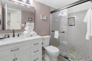 a bathroom with a shower and a toilet and a sink at Litchfield By the Sea 3BR Tranquil Retreat in Pawleys Island +17 photos