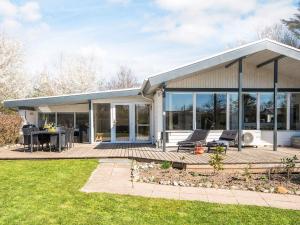 a house with a large deck with chairs on it at 6 person holiday home in Sydals-By Traum in Sønderby