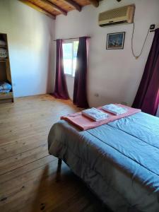 ein Schlafzimmer mit einem Bett mit zwei Handtüchern darauf in der Unterkunft Alojamiento Centrico con Cochera in San Pedro