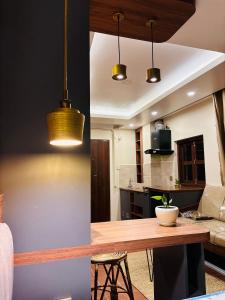 a kitchen and living room with a wooden table at The Ganesh Kuti in Pātan