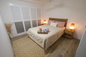 Un dormitorio con una cama con un osito de peluche encima. en Campbells Cove Unit 12, en Caloundra 8 fotos más