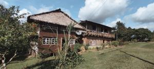 an old house with a balcony on the side of it at Hospedaje KOWAPANA BOCAS DE AMACAYACU in San Martín