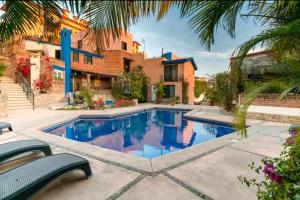 a swimming pool in front of a house at Toro 1, Oro y Azul in Cabo San Lucas