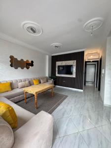 a living room with a couch and a table at Mini Villa alhoceima in El Arba de Trougout