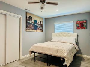 a bedroom with a bed and a ceiling fan at Beautiful Stay in Moreno Valley - Close to parks in Moreno Valley