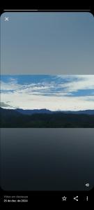 a computer screen with a view of the ocean at Pousada Bella Montanha in Louro Müller