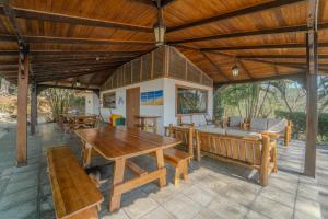 an outdoor patio with a wooden table and benches at Corozalito Turtle Inn in Nandayure