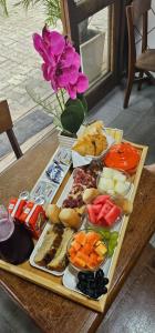 a tray of food on a table with food at Pousada Marina do Sol in Florianópolis