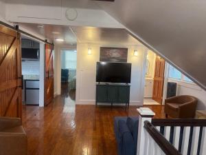 a living room with a flat screen tv and a couch at Cape Cod Hyannis Rendezvous' in Barnstable