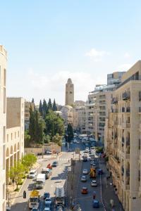 a city street filled with traffic in a city at The MAZ Jerusalem in Jerusalem