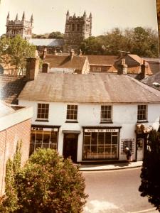 an old photo of a building in a town at West Street Views #1 - Beautiful town centre apartment in Wimborne Minster