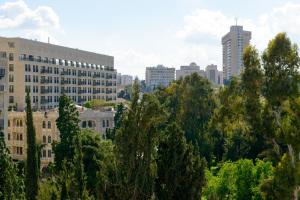 a city skyline with tall buildings and trees at The MAZ Jerusalem in Jerusalem
