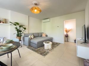 a living room with a couch and a tv at Genk Central Apartment in Genk