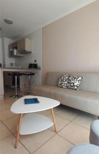 a living room with a couch and a table at Departamento Central 1D - Wifi - Parking in Antofagasta