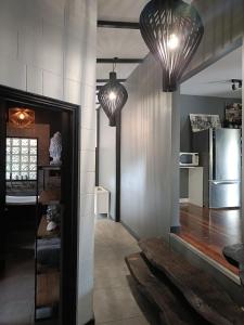 a hallway with two pendant lights and a kitchen at Rakali Retreat in Cooran
