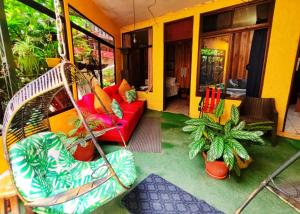 a living room with a couch and a swing at Cabinas El Pueblo B&B Monteverde in Monteverde Costa Rica
