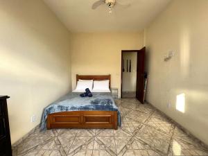 a bedroom with a bed with a pair of shoes on it at Apto na beira da praia do Centro | ROMM207 in Rio das Ostras