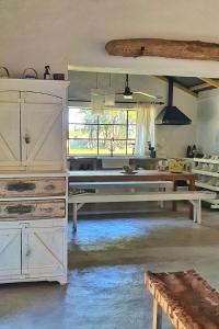 a large room with white cabinets and a table at El Rancho - Hospedaje Rural in Navarro +27 photos