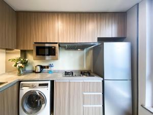 a kitchen with a washer and a white refrigerator at Tyms APT Hengshan RD Near IAPM K11 Line9 in Shanghai